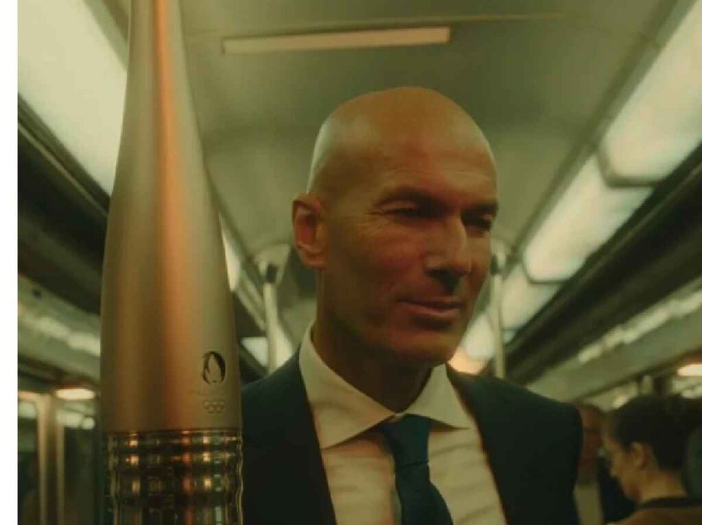 Zinedine Zidane, París 2024, Juegos Olímpicos, ceremonia inaugural, antorcha olímpica, Stade de France, deporte, Francia, atletas, espectadores, legado, esperanza, niños, capital francesa, cultura francesa, unidad global, evento deportivo, recorrido emblemático, historia olímpica.